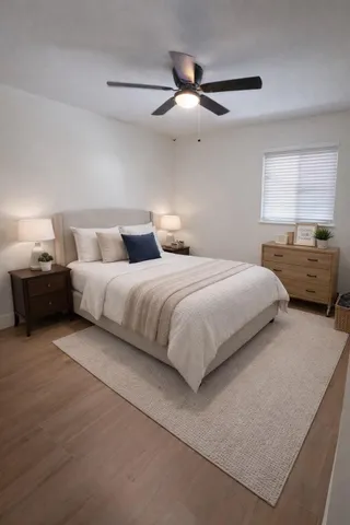 a bedroom with a bed and ceiling fan