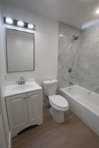 a bathroom with a toilet sink and mirror