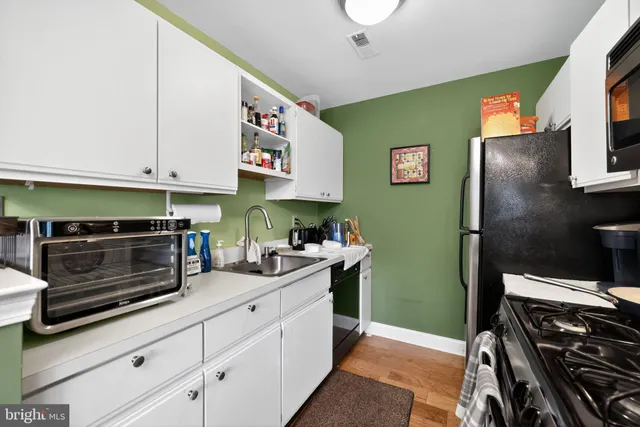a kitchen with stainless steel appliances and cabinets