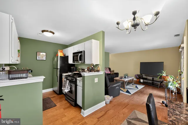 a kitchen with a sink appliances and cabinets
