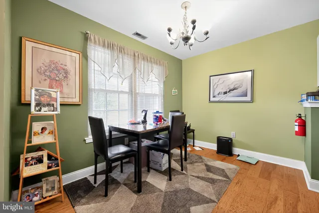 a view of a dining room with furniture and a window