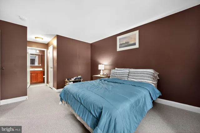 a bedroom with a bed and a large mirror