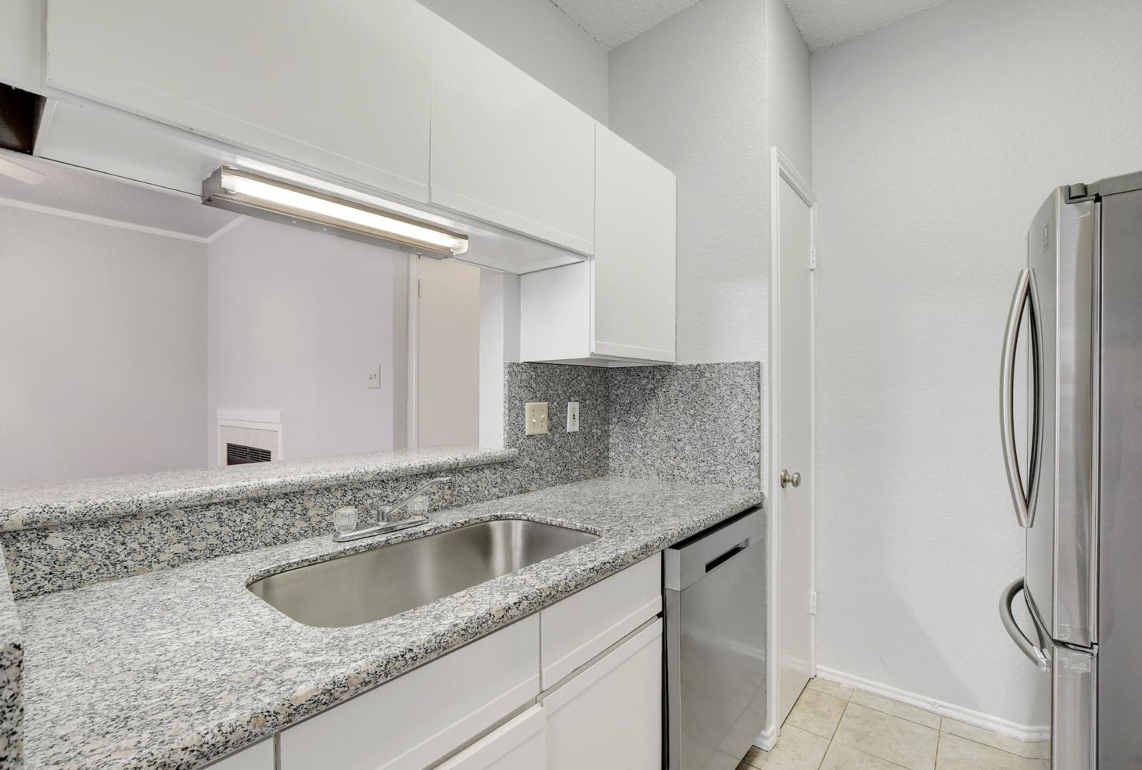 2804 Rio Grande Street, Unit 310 Austin, TX 78705 - Photo 11 of 22 A well-appointed kitchen features ample counter space, streamlined cabinetry, and essential appliances.