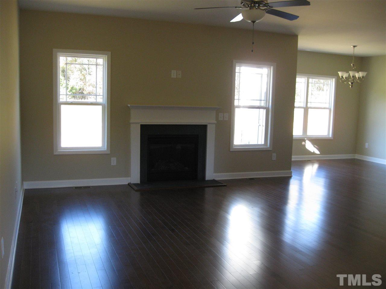 7862 Creech Road Middlesex, NC 27557 - Photo 2 of 12 an empty room with wooden floor and windows