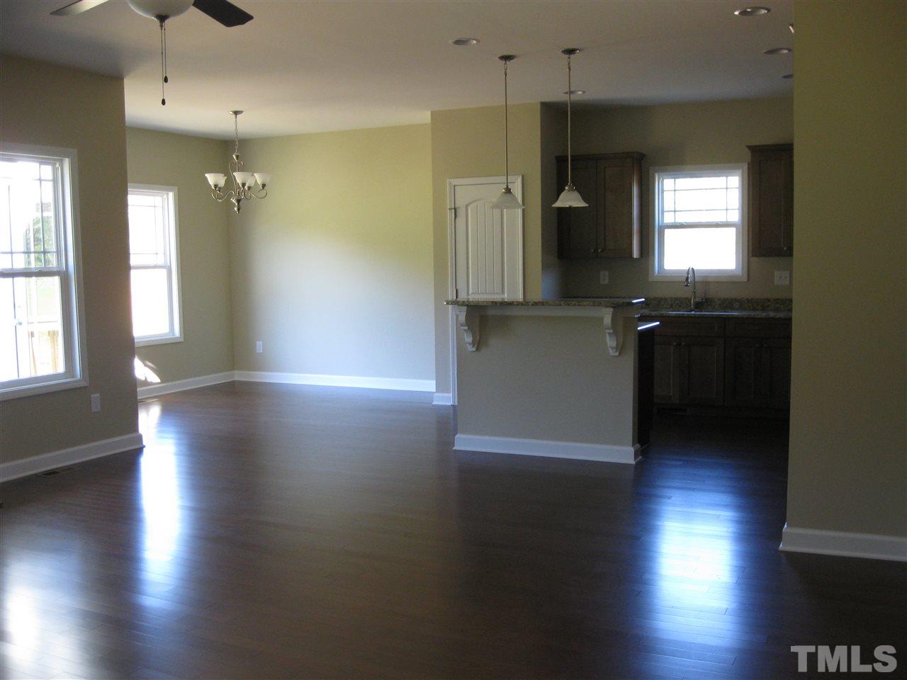 7862 Creech Road Middlesex, NC 27557 - Photo 3 of 12 an empty room with wooden floor and windows