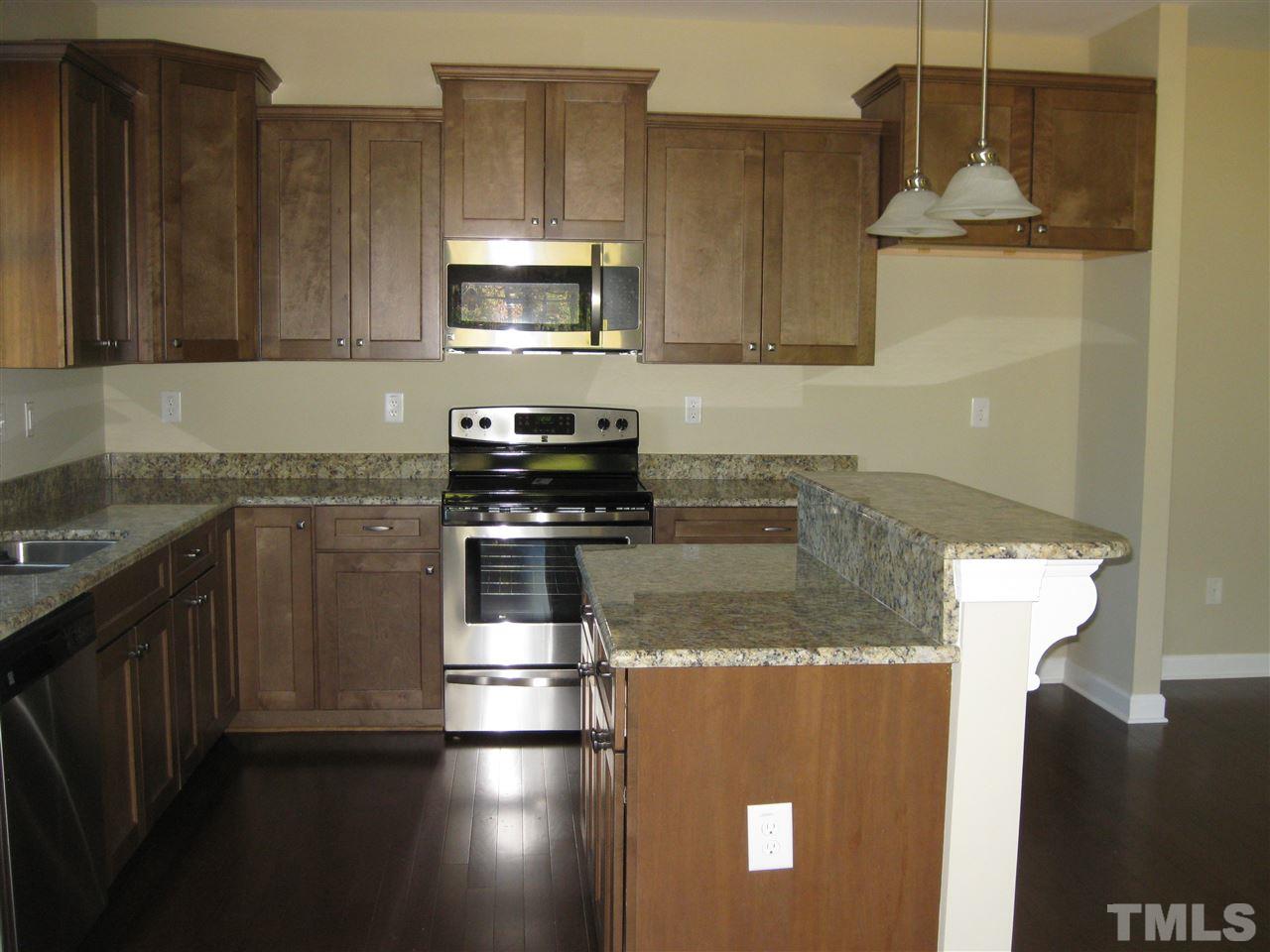 7862 Creech Road Middlesex, NC 27557 - Photo 4 of 12 a kitchen with stainless steel appliances granite countertop a sink a stove and a microwave