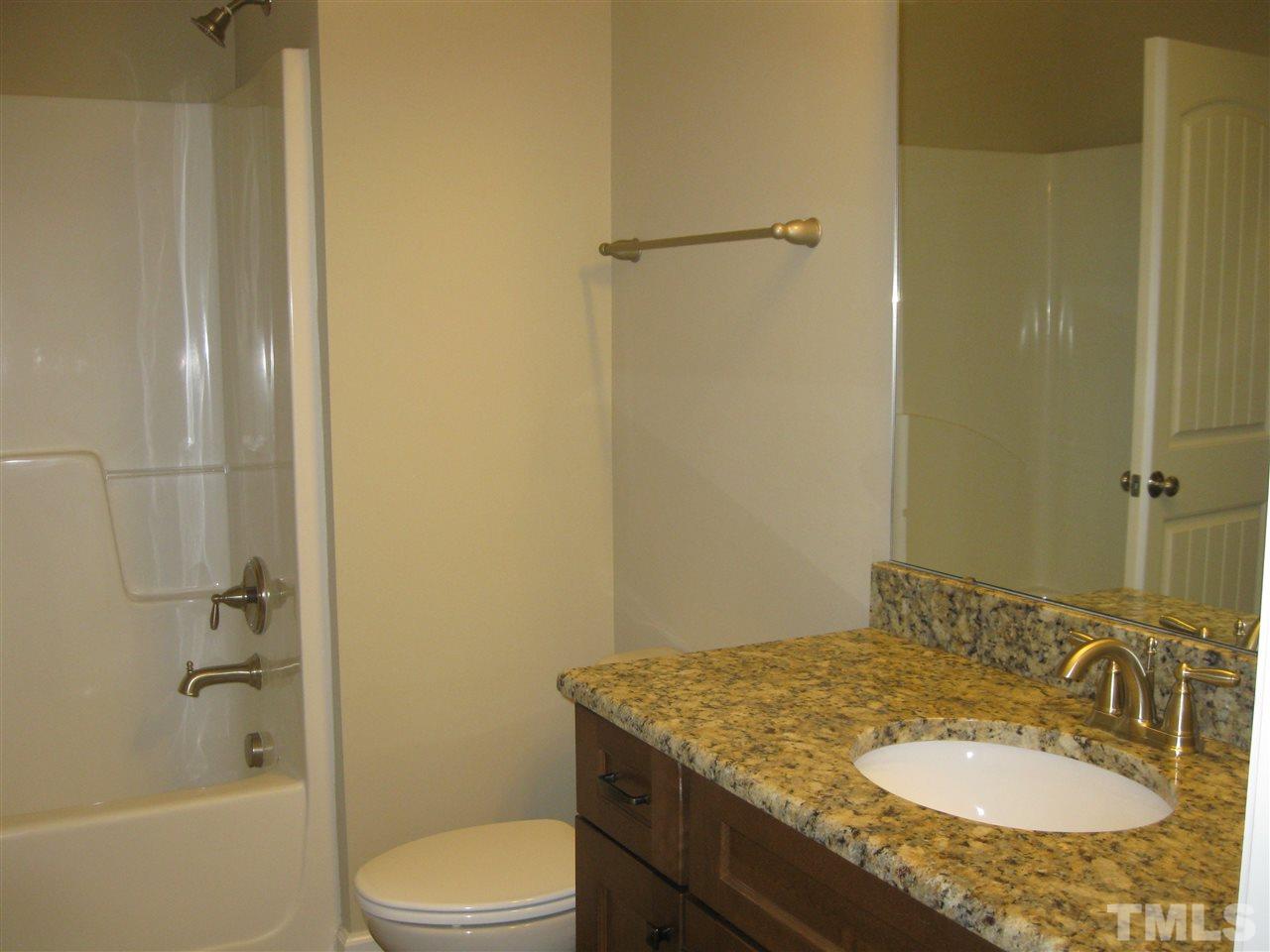 7862 Creech Road Middlesex, NC 27557 - Photo 6 of 12 a bathroom with a granite countertop sink toilet and shower