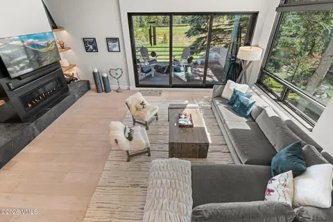 a living room with furniture and a floor to ceiling window