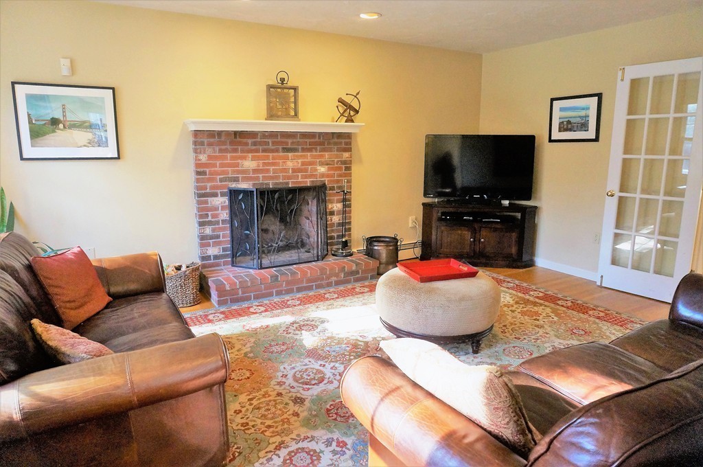 12 Barbara Road Sudbury, MA 01776 - Photo 11 of 26 a living room with furniture and a flat screen tv