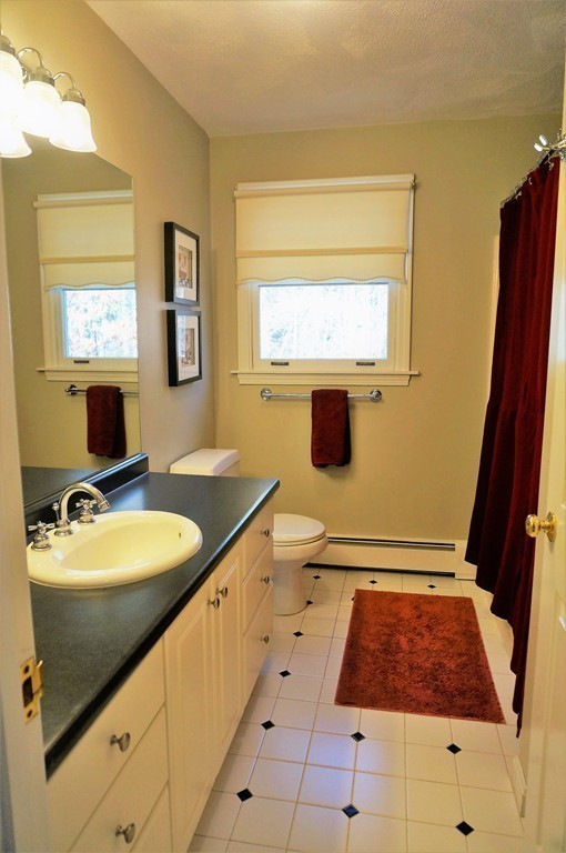 12 Barbara Road Sudbury, MA 01776 - Photo 18 of 26 a bathroom with a sink a mirror and a bathtub