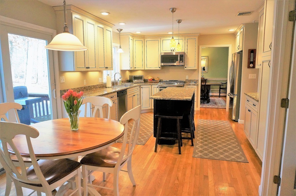 12 Barbara Road Sudbury, MA 01776 - Photo 6 of 26 a kitchen with stainless steel appliances kitchen island granite countertop a table chairs and a refrigerator