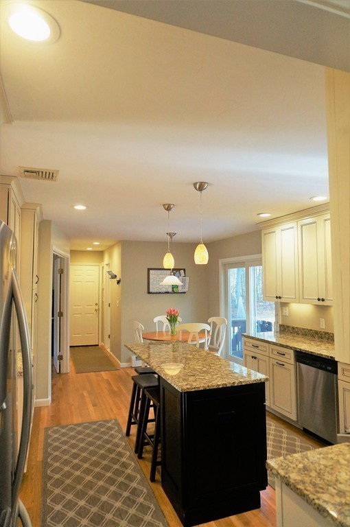 12 Barbara Road Sudbury, MA 01776 - Photo 7 of 26 a kitchen with stainless steel appliances granite countertop a sink stove and refrigerator