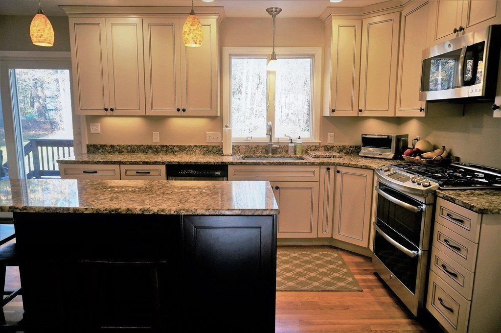 12 Barbara Road Sudbury, MA 01776 - Photo 8 of 26 a kitchen with stainless steel appliances granite countertop a stove a sink and a microwave