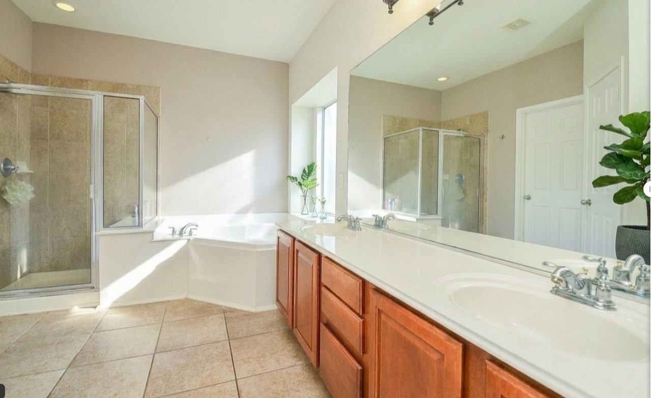19802 Shavon Springs Drive Spring, TX 77388 - Photo 18 of 30 Luxurious primary bath featuring a spacious double vanity, elegant soaking tub, and a walk-in shower, all bathed in natural light.