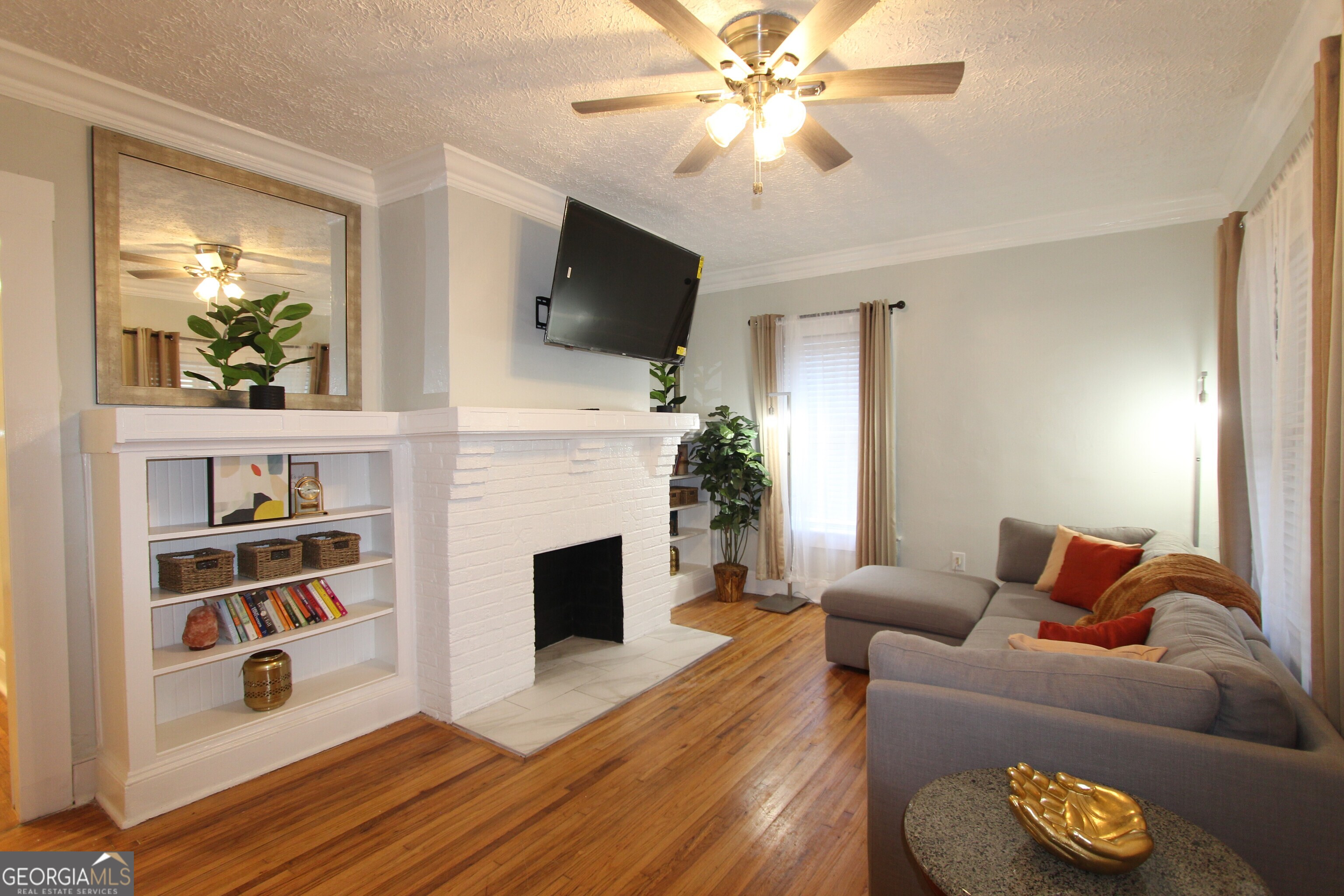 a living room with furniture fireplace and flat screen tv
