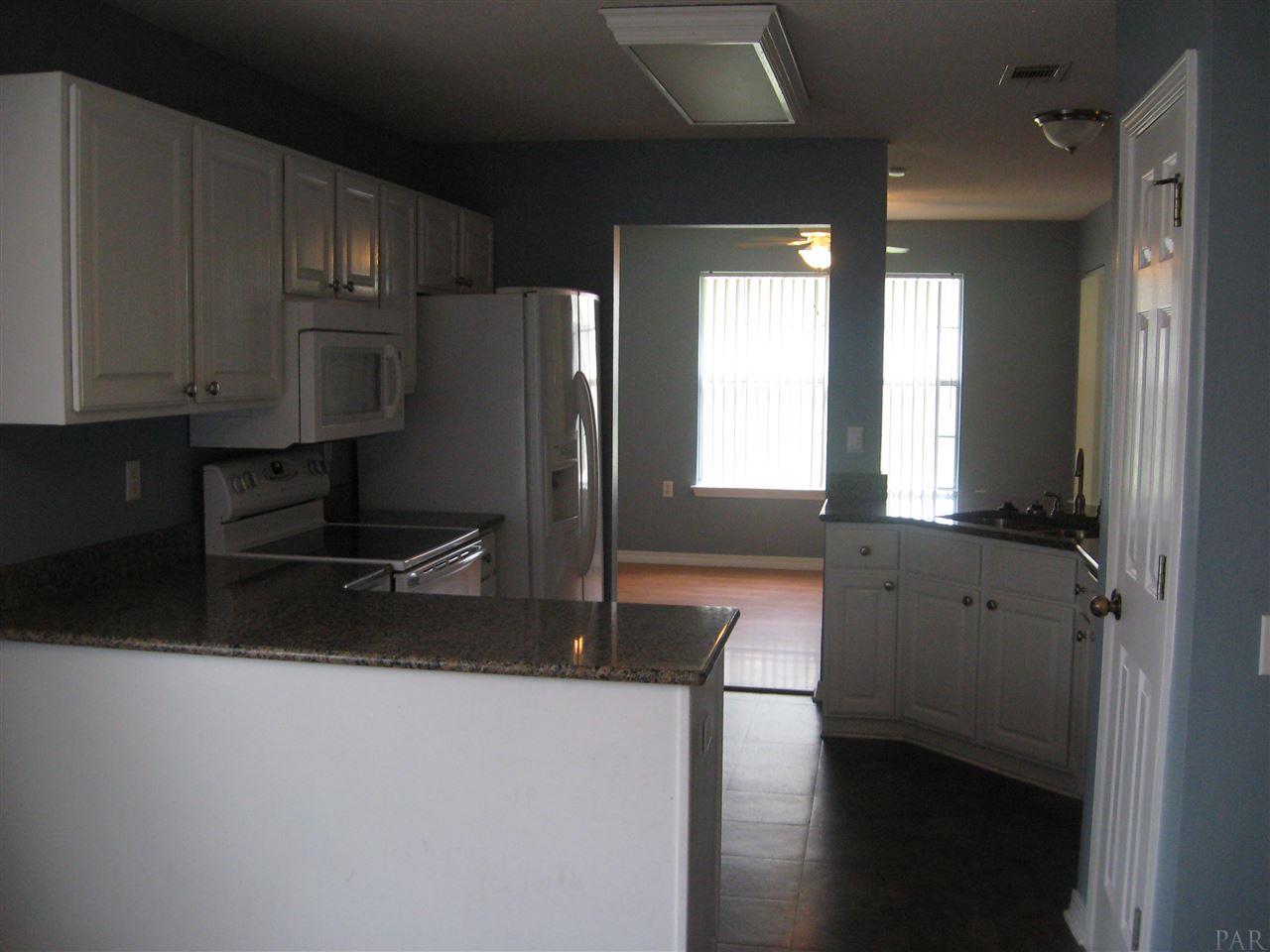 1023 Brownfield Road Pensacola, FL 32526 - Photo 1 of 4 a kitchen with stainless steel appliances granite countertop a refrigerator and a sink
