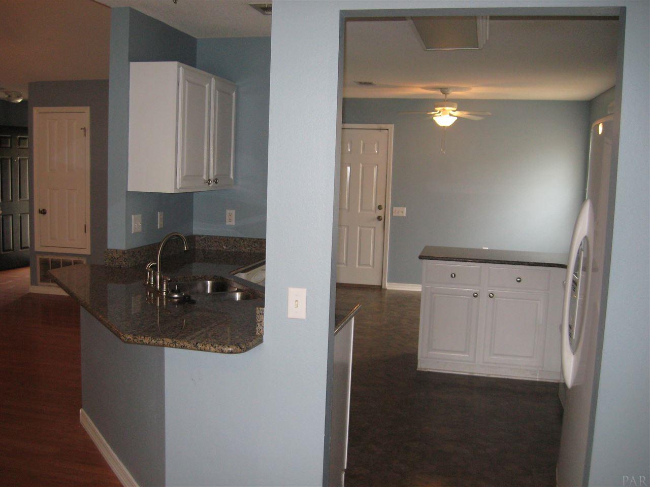 1023 Brownfield Road Pensacola, FL 32526 - Photo 2 of 4 a kitchen with sink cabinets and stove
