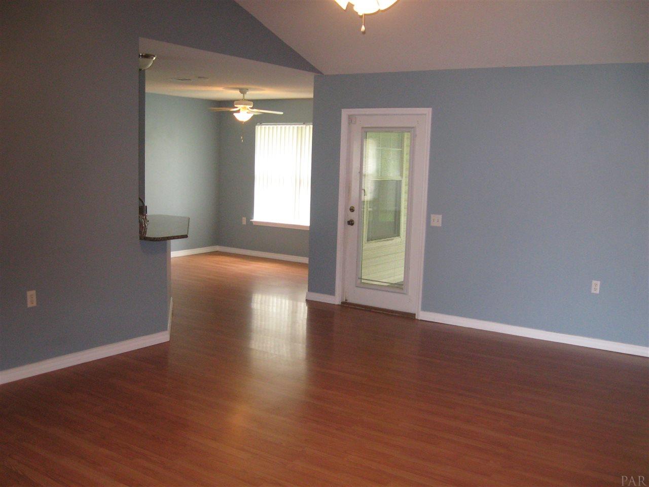 1023 Brownfield Road Pensacola, FL 32526 - Photo 3 of 4 a view of an empty room with wooden floor and a window