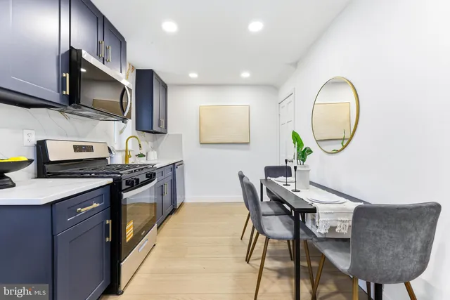 a kitchen with stainless steel appliances granite countertop a refrigerator and a sink