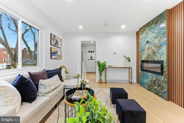 a living room with furniture and a floor to ceiling window