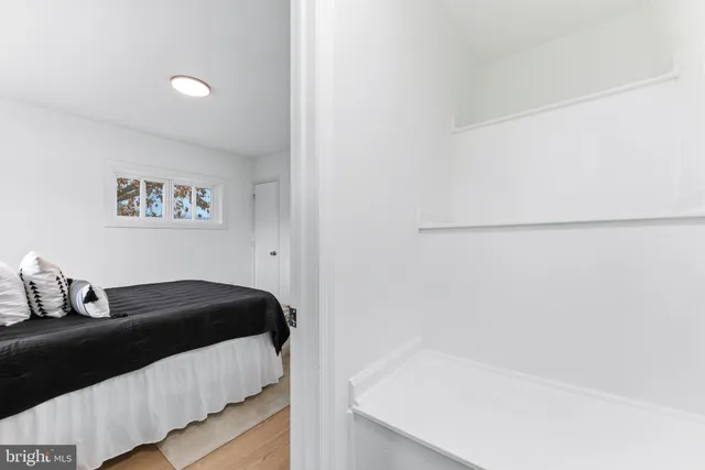 a bed room with a bed and a painting on the wall