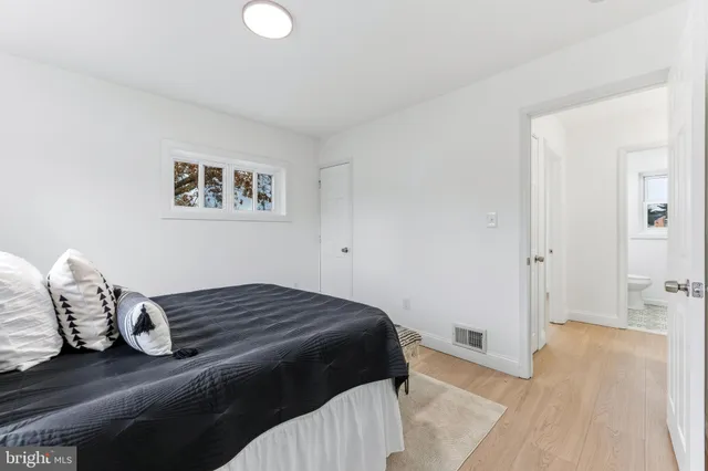 a bedroom with two beds and a couch