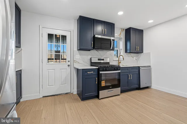 a kitchen with a sink and a stove top oven