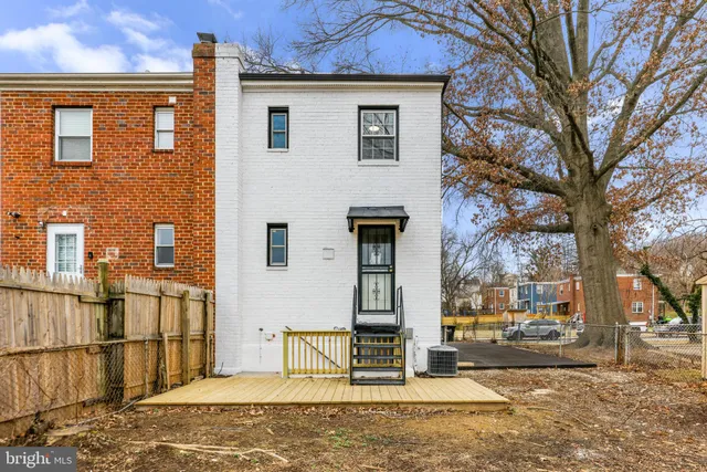 a view of a yard with wooden fence