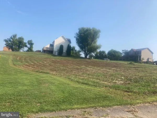 a view of a field with an ocean