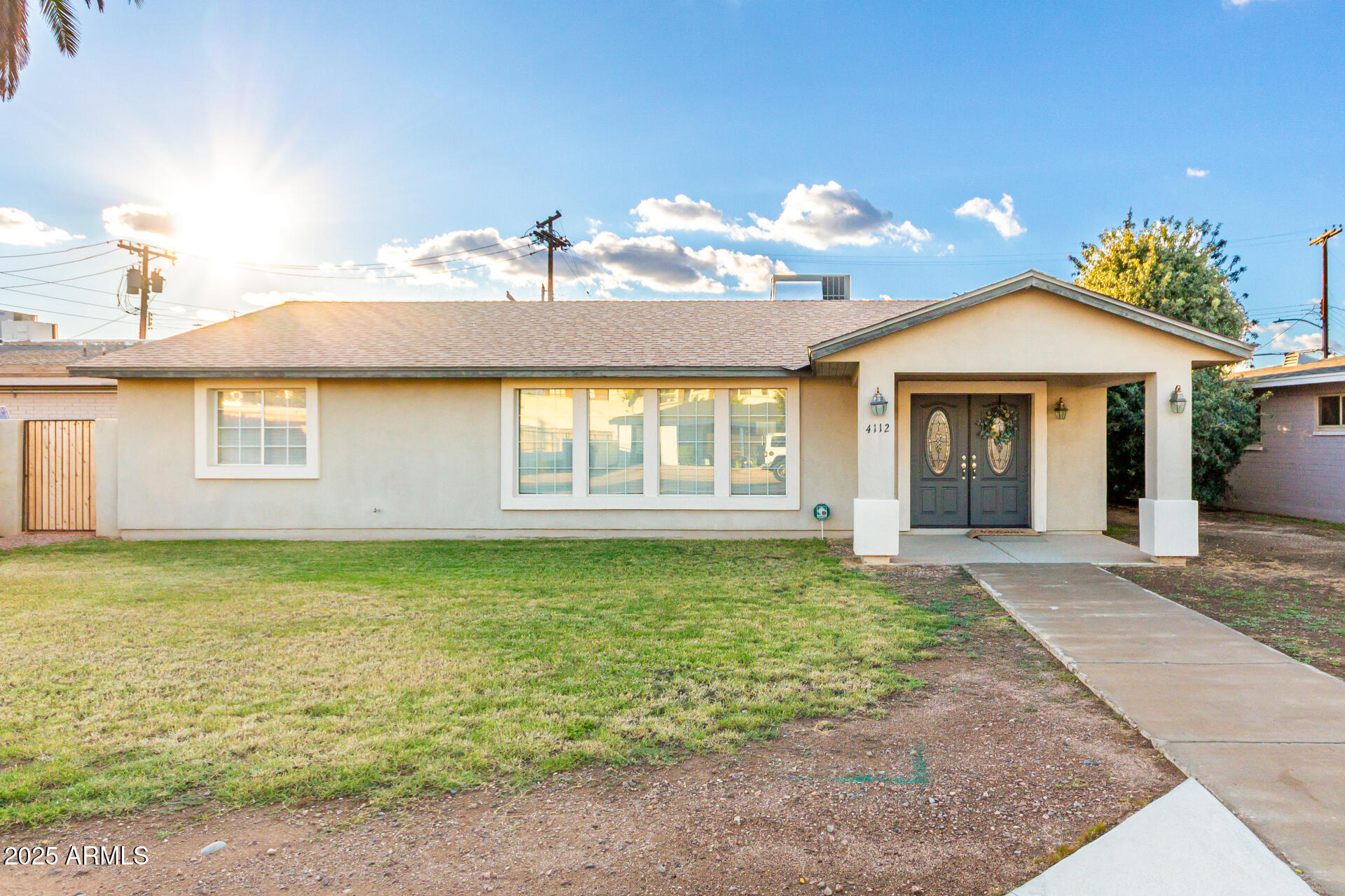 4112 4th Avenue Northwest Phoenix, AZ 85013 - Photo 1 of 39 a front view of a house with garden