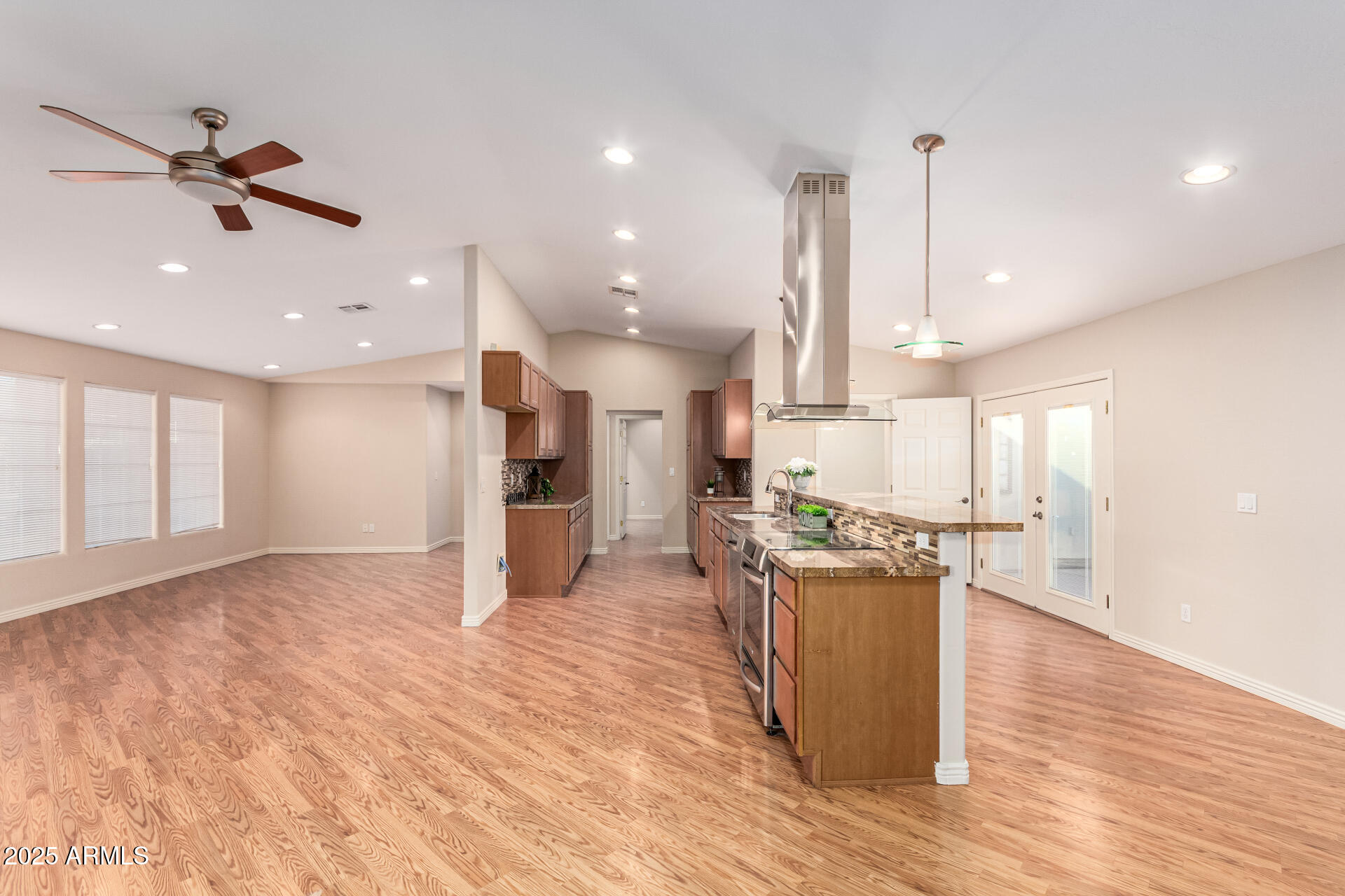 4112 4th Avenue Northwest Phoenix, AZ 85013 - Photo 11 of 39 a view of a kitchen with kitchen island a stove a sink wooden floor and a window
