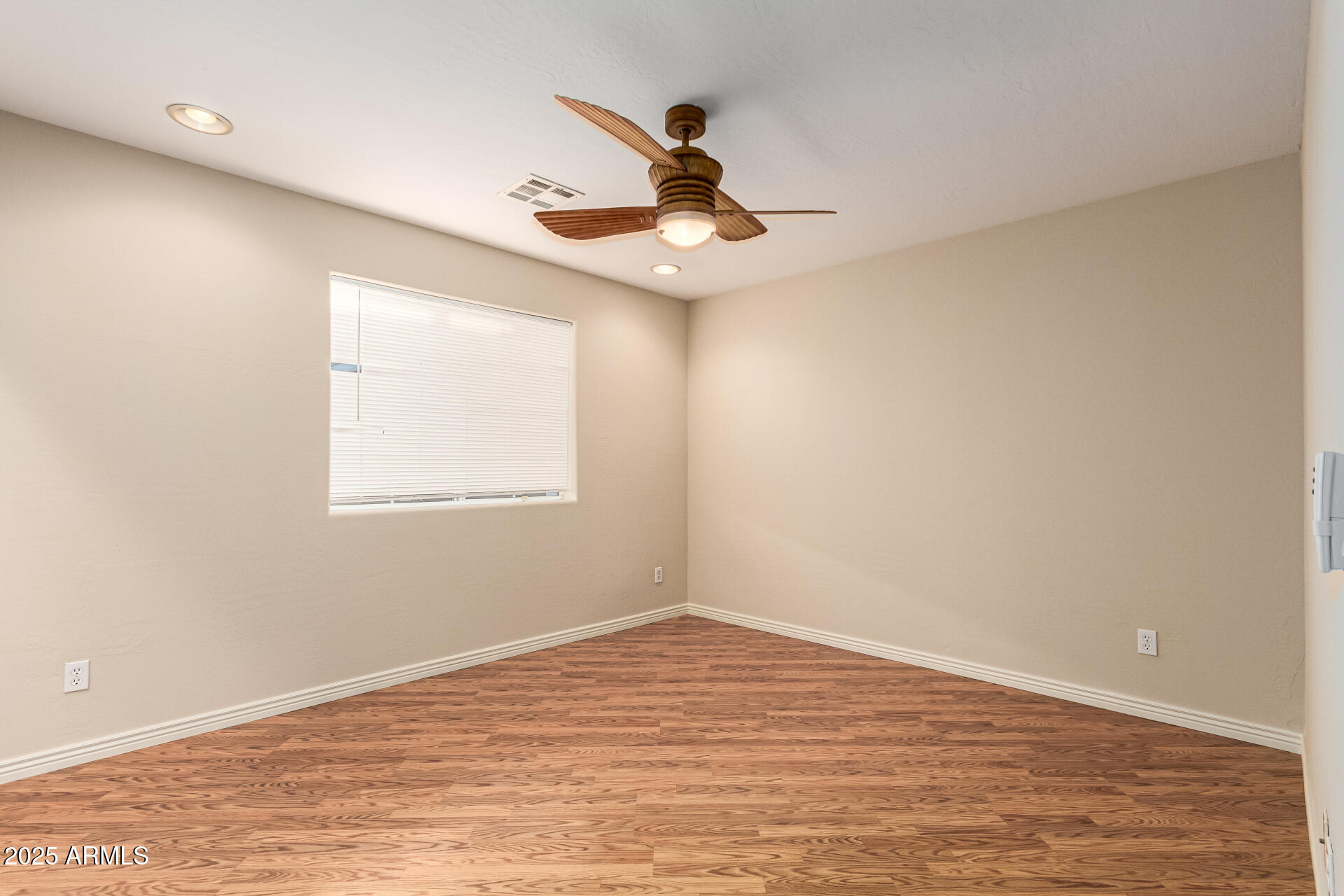 4112 4th Avenue Northwest Phoenix, AZ 85013 - Photo 26 of 39 a view of an empty room with wooden floor and a window