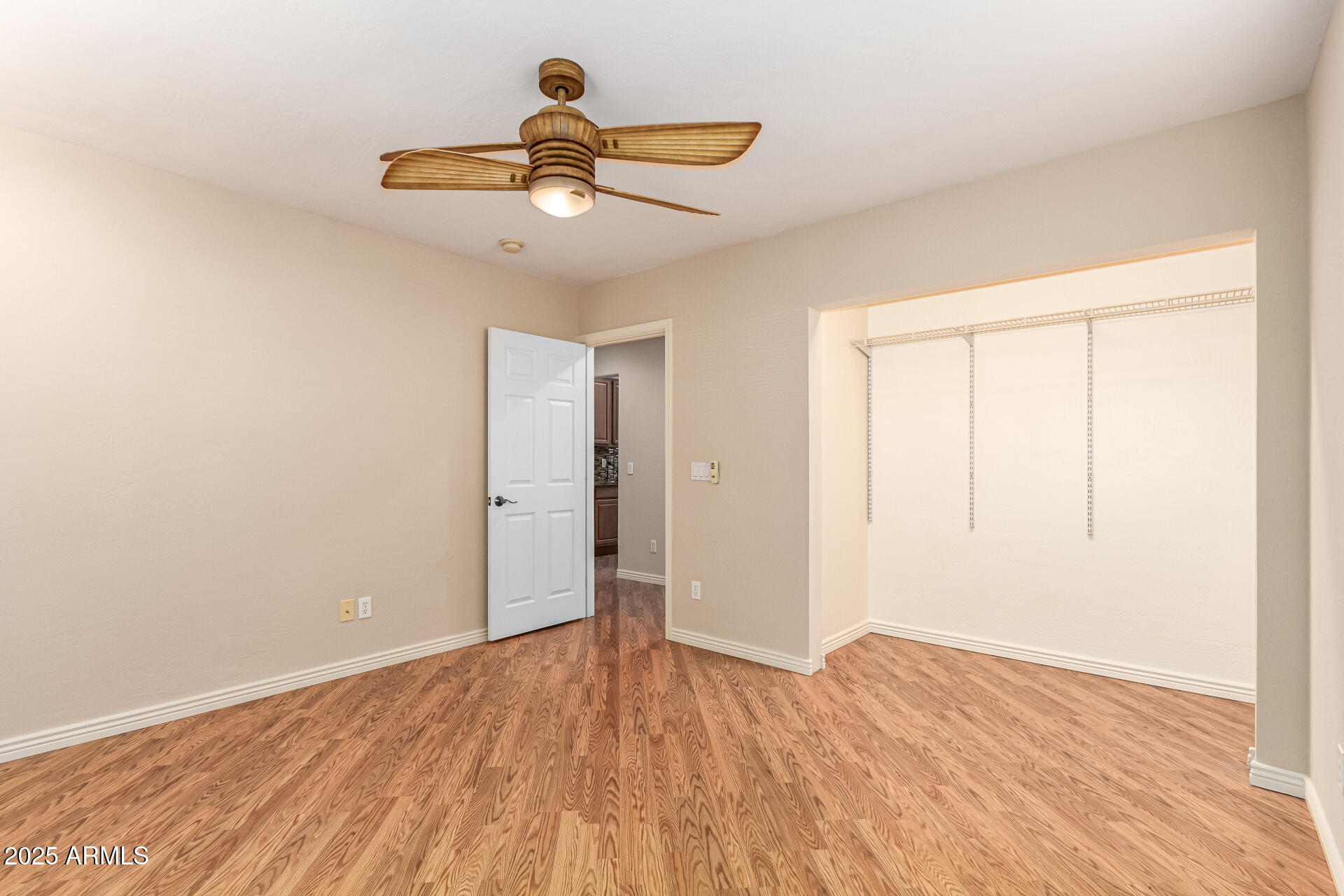 4112 4th Avenue Northwest Phoenix, AZ 85013 - Photo 30 of 39 an empty room with wooden floor closet and ceiling fan