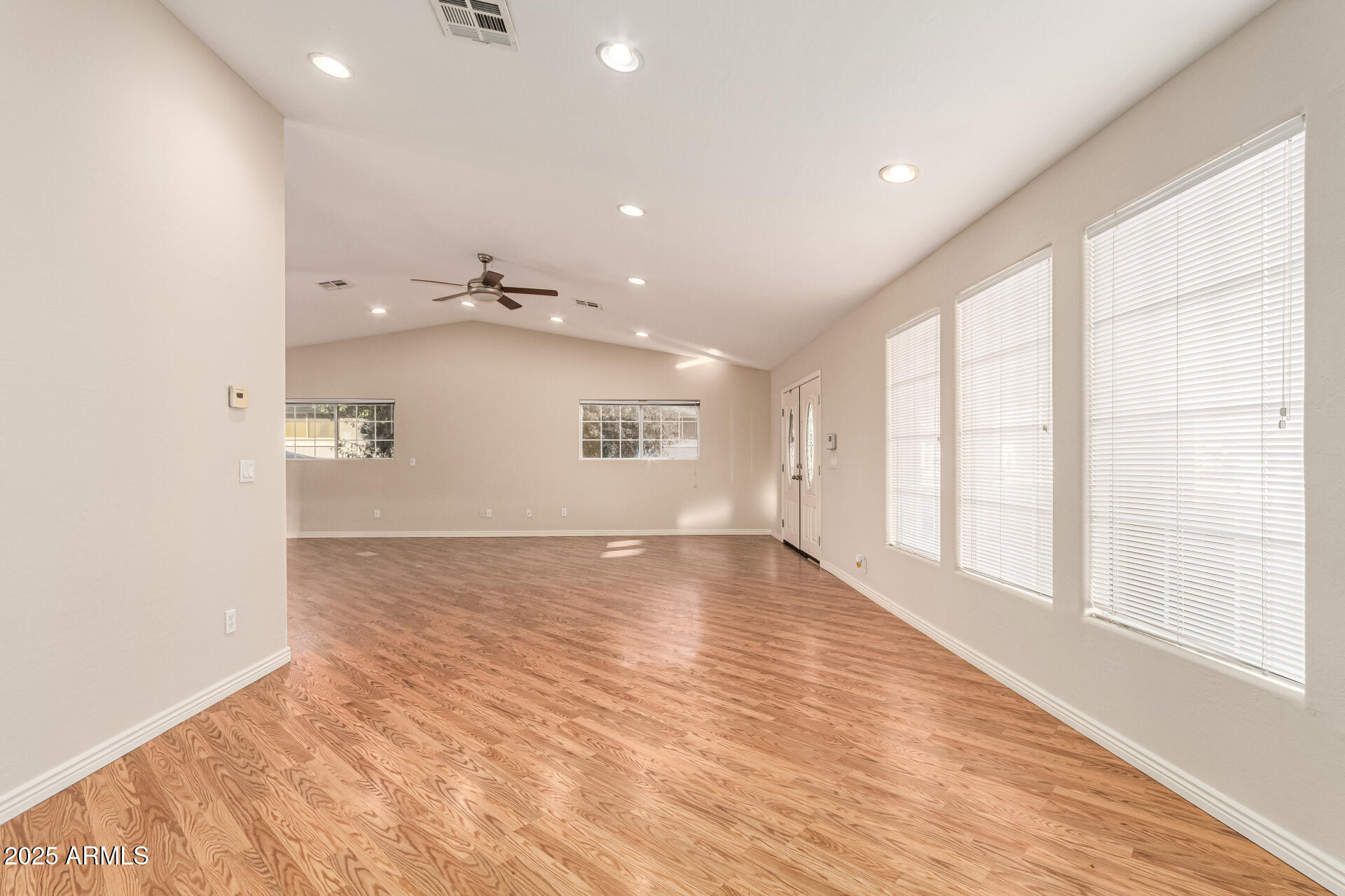 4112 4th Avenue Northwest Phoenix, AZ 85013 - Photo 6 of 39 an empty room with wooden floor and windows