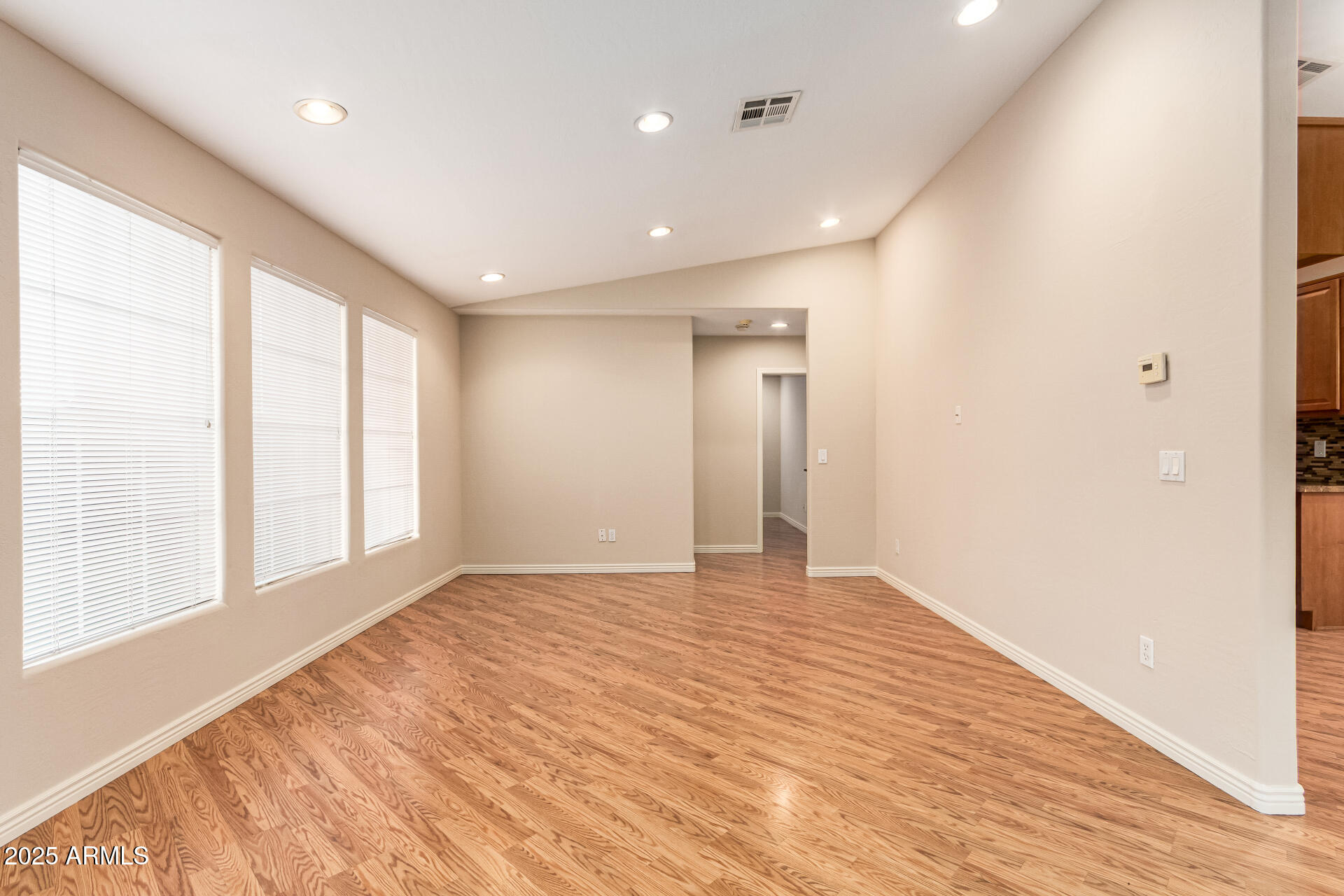 4112 4th Avenue Northwest Phoenix, AZ 85013 - Photo 7 of 39 a view of an empty room with wooden floor and a window