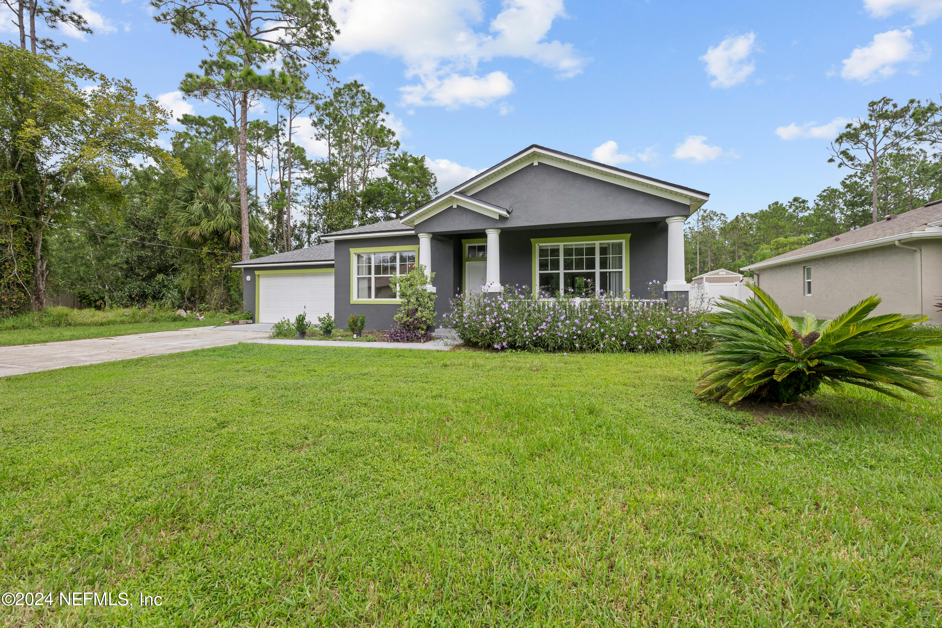a front view of house with yard and green space