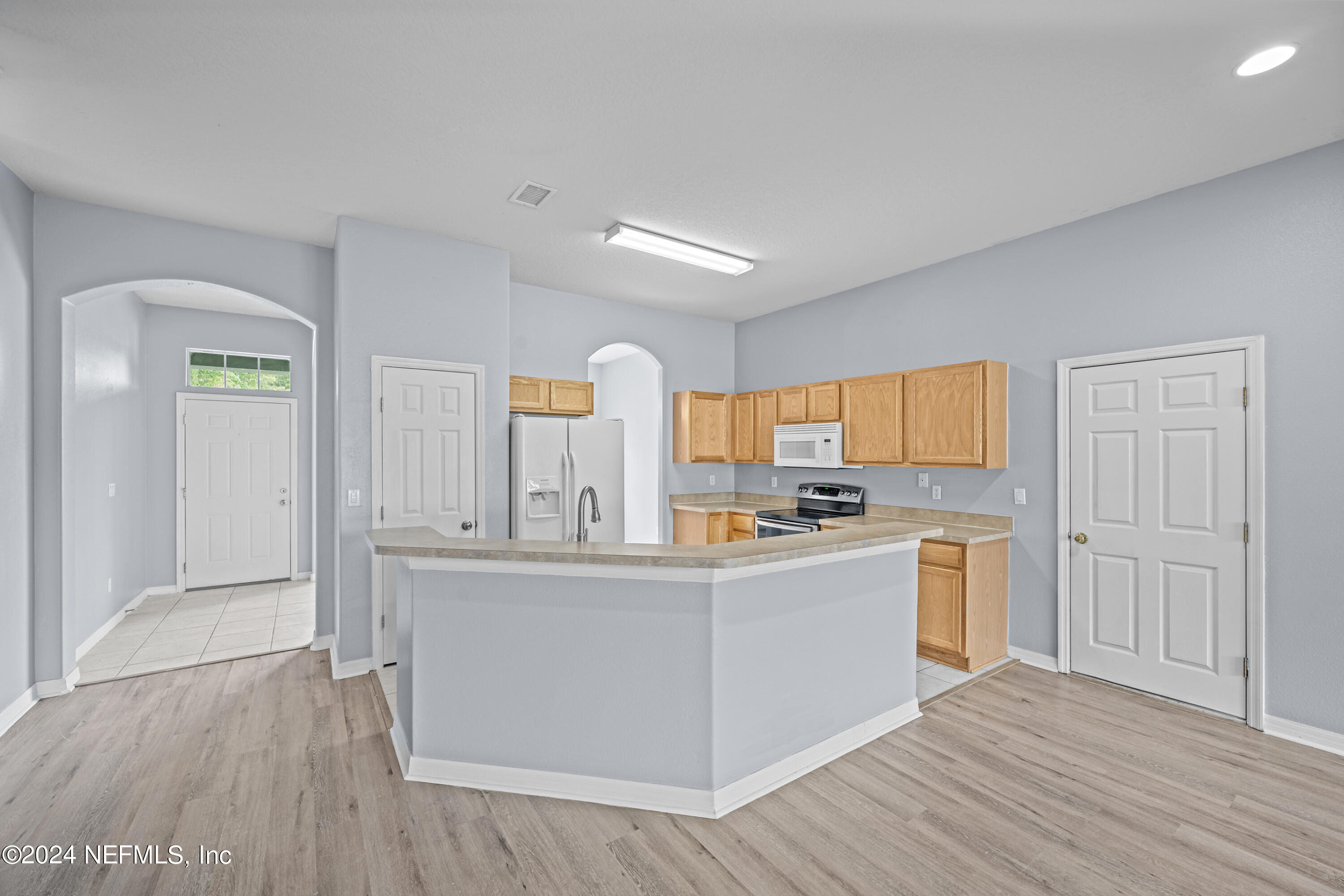26 Zonal Geranium Trail Palm Coast, FL 32164 - Photo 11 of 35 a kitchen with cabinets and wooden floor