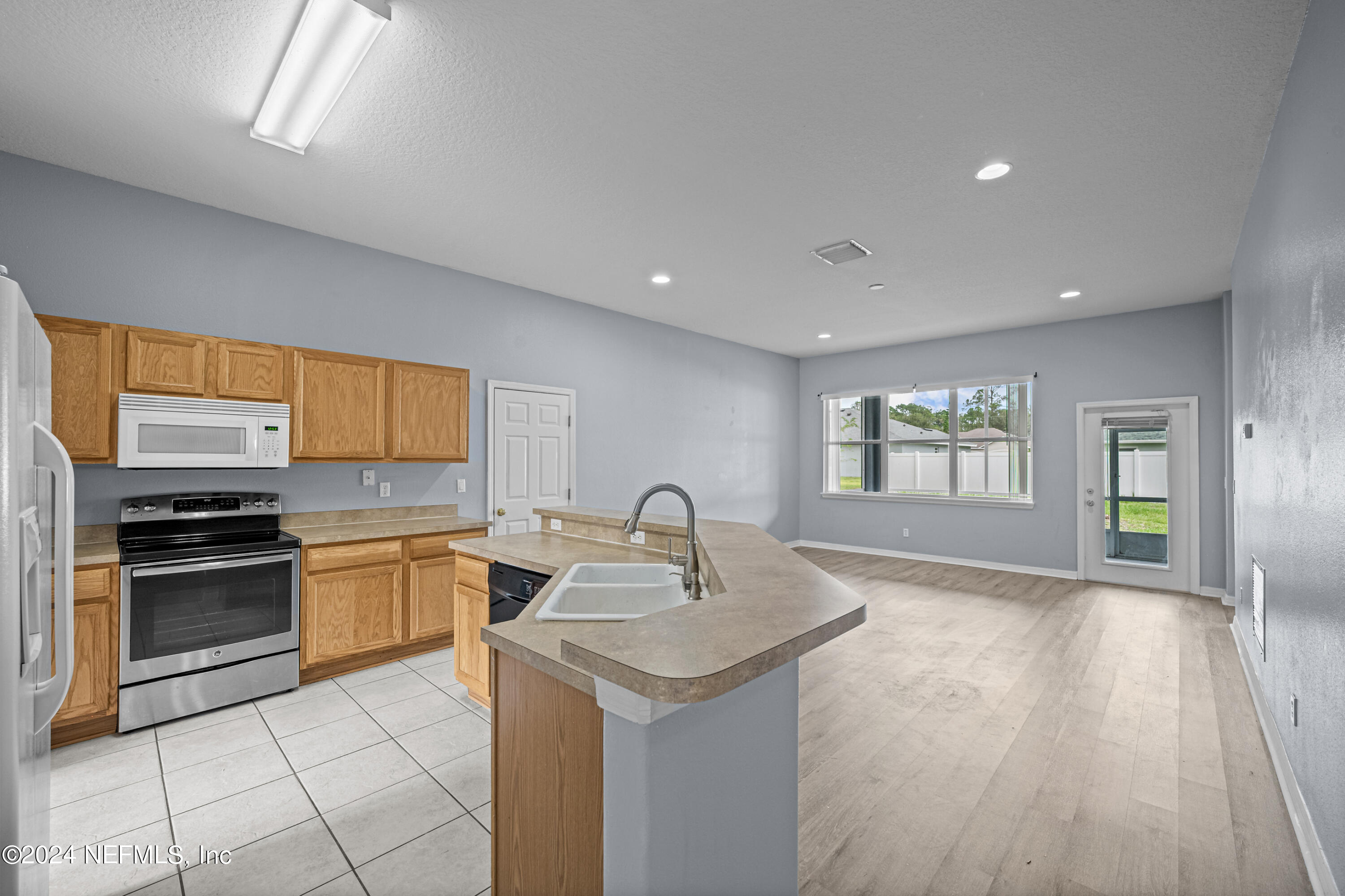 26 Zonal Geranium Trail Palm Coast, FL 32164 - Photo 14 of 35 a kitchen with granite countertop a sink and a stove top oven