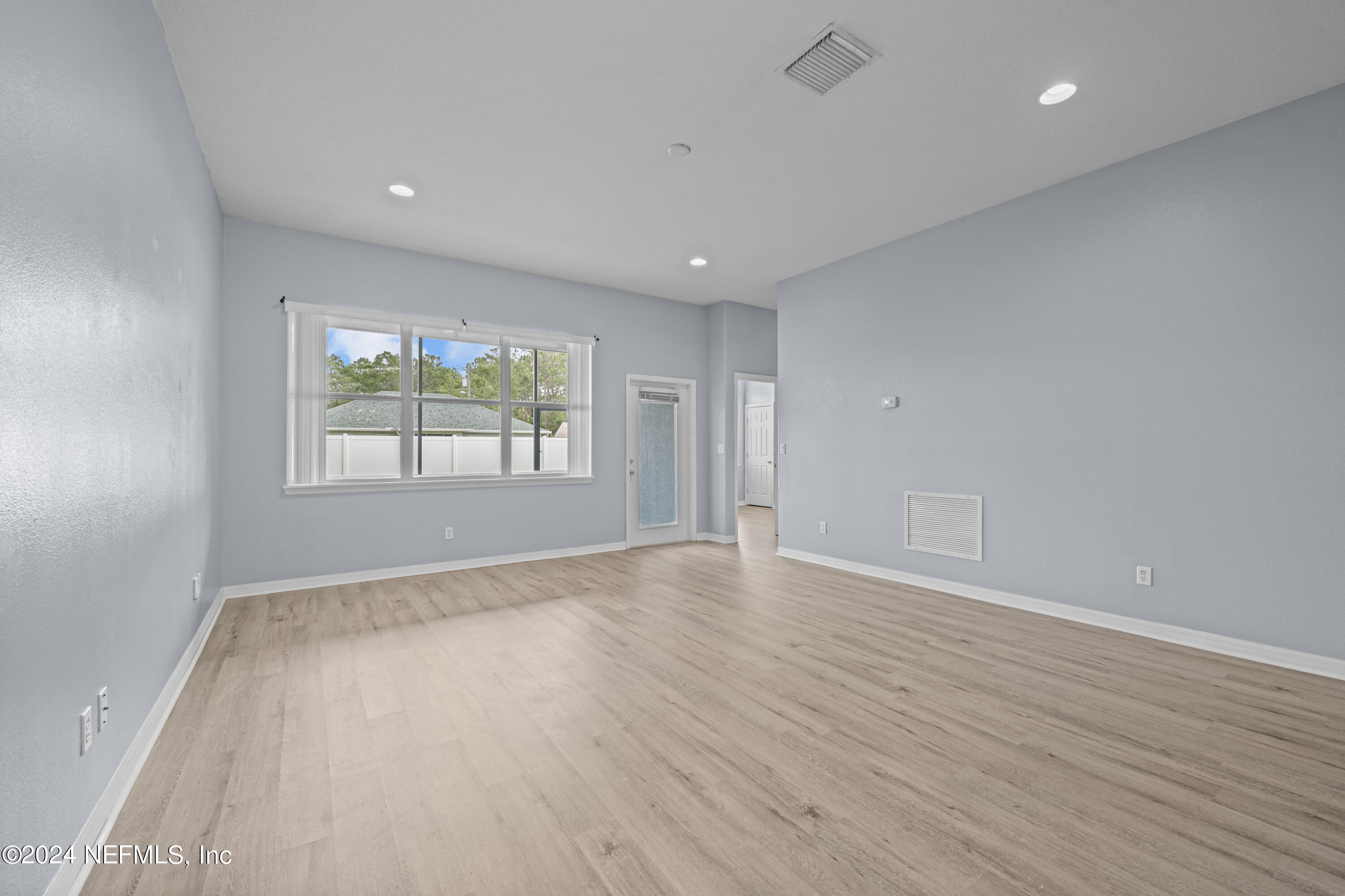 26 Zonal Geranium Trail Palm Coast, FL 32164 - Photo 17 of 35 an empty room with wooden floor and windows