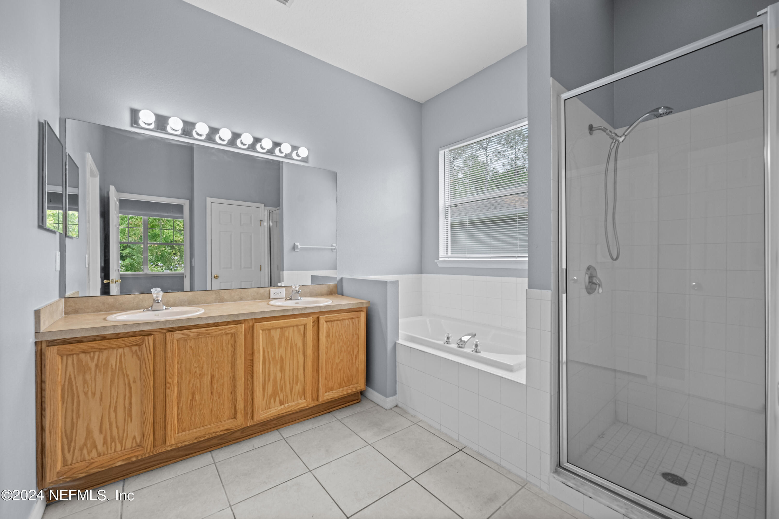 26 Zonal Geranium Trail Palm Coast, FL 32164 - Photo 21 of 35 a bathroom with a granite countertop sink mirror and bathtub