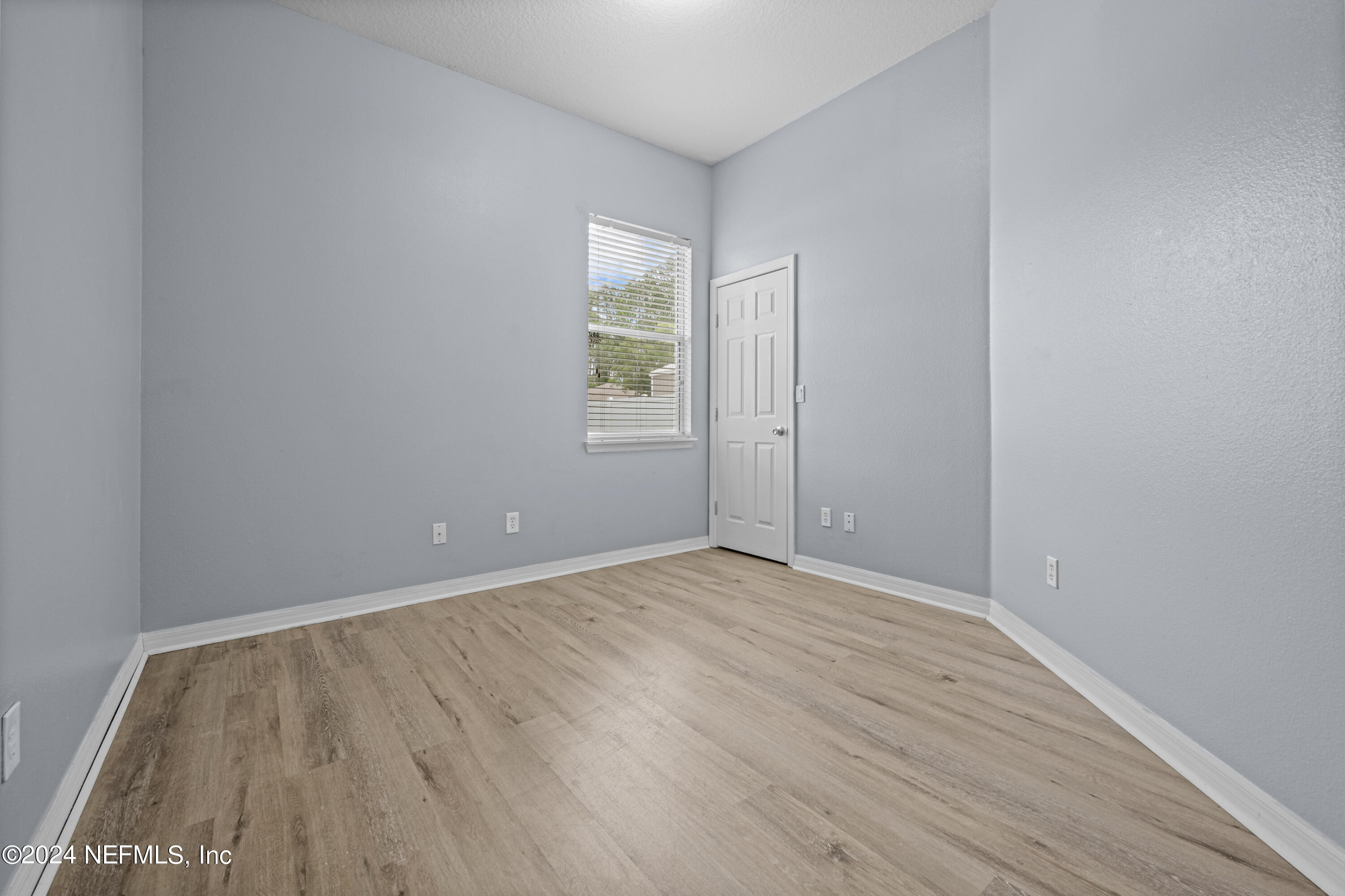 26 Zonal Geranium Trail Palm Coast, FL 32164 - Photo 22 of 35 a view of an empty room with wooden floor and a window