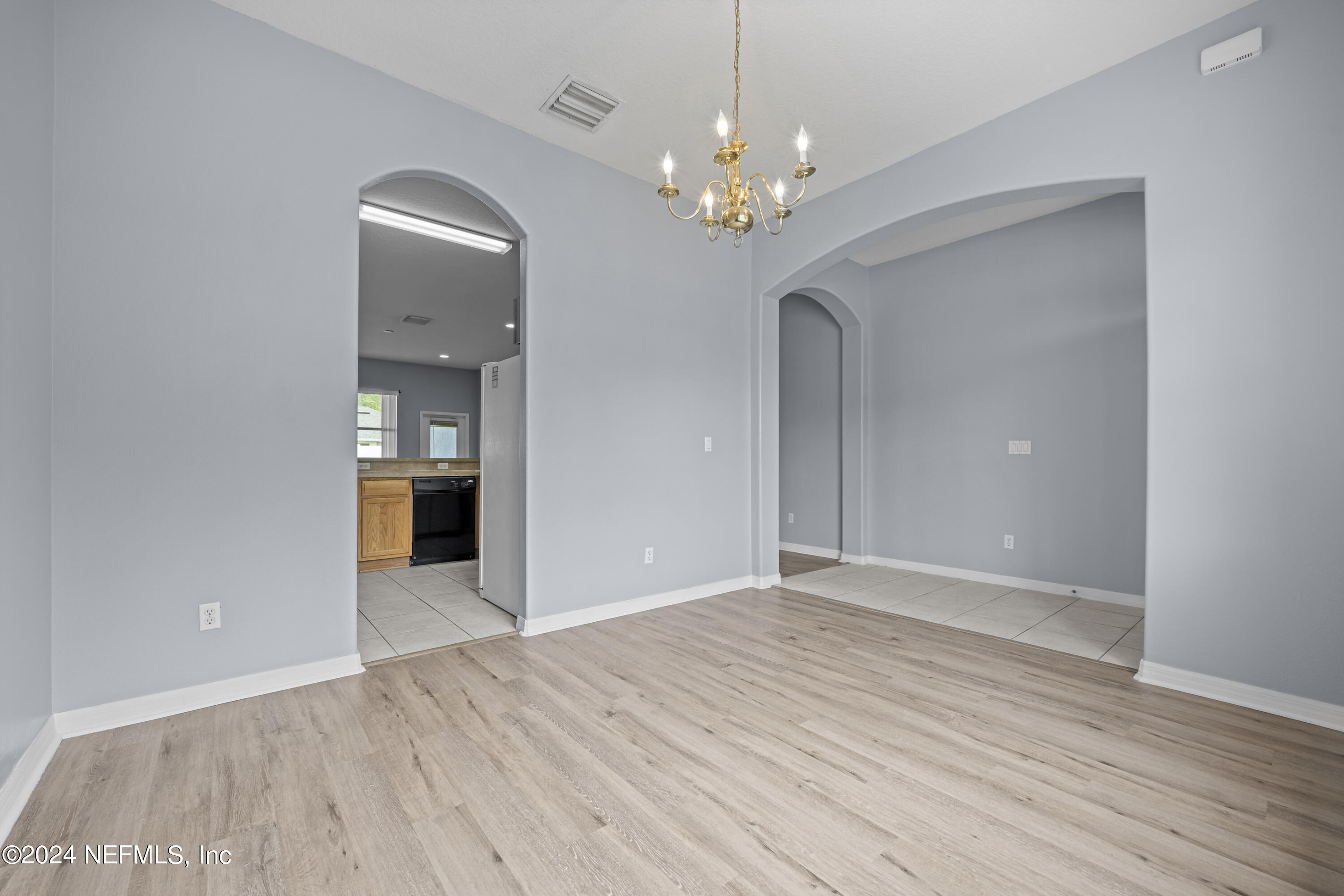 26 Zonal Geranium Trail Palm Coast, FL 32164 - Photo 9 of 35 a view of an empty room with wooden floor and a bathroom