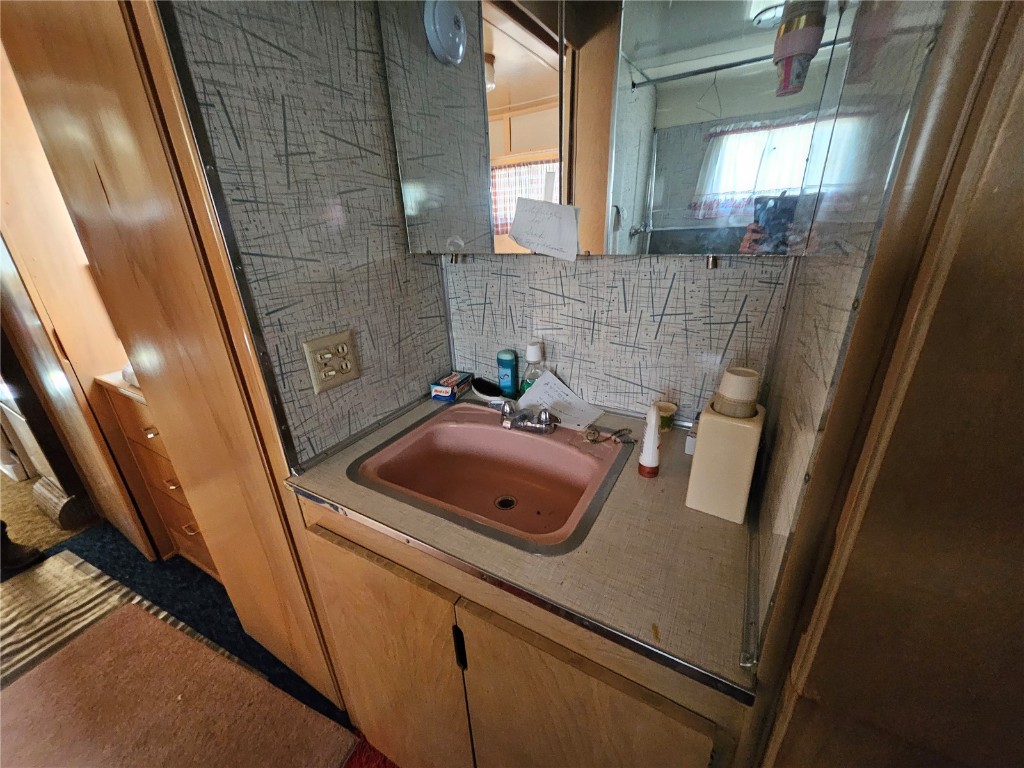 1404 Buffalo Ridge Road Como, CO 80432 - Photo 22 of 50 a bathroom with a sink a mirror and shower