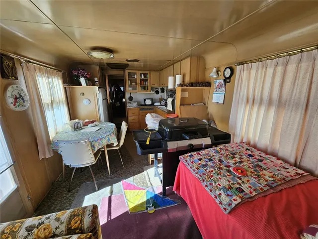 a kitchen with a refrigerator and a table