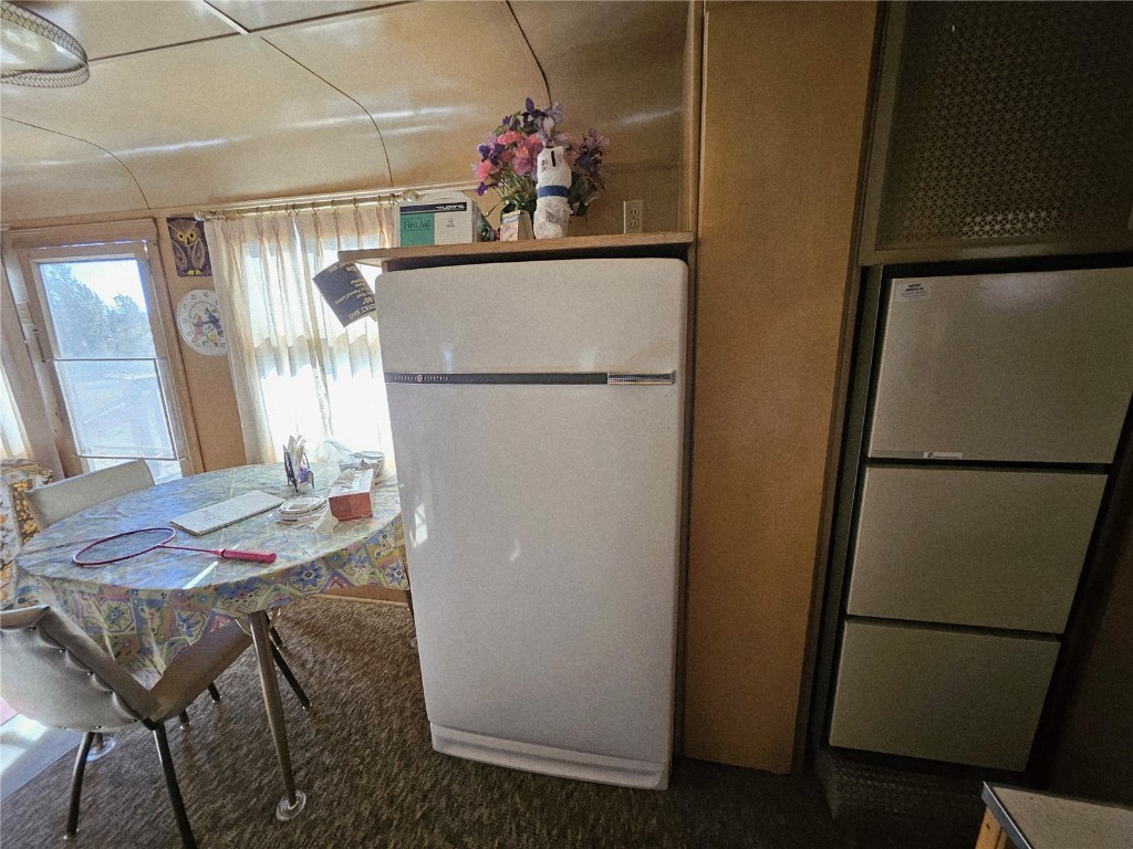 1404 Buffalo Ridge Road Como, CO 80432 - Photo 29 of 50 a kitchen with a refrigerator and a table