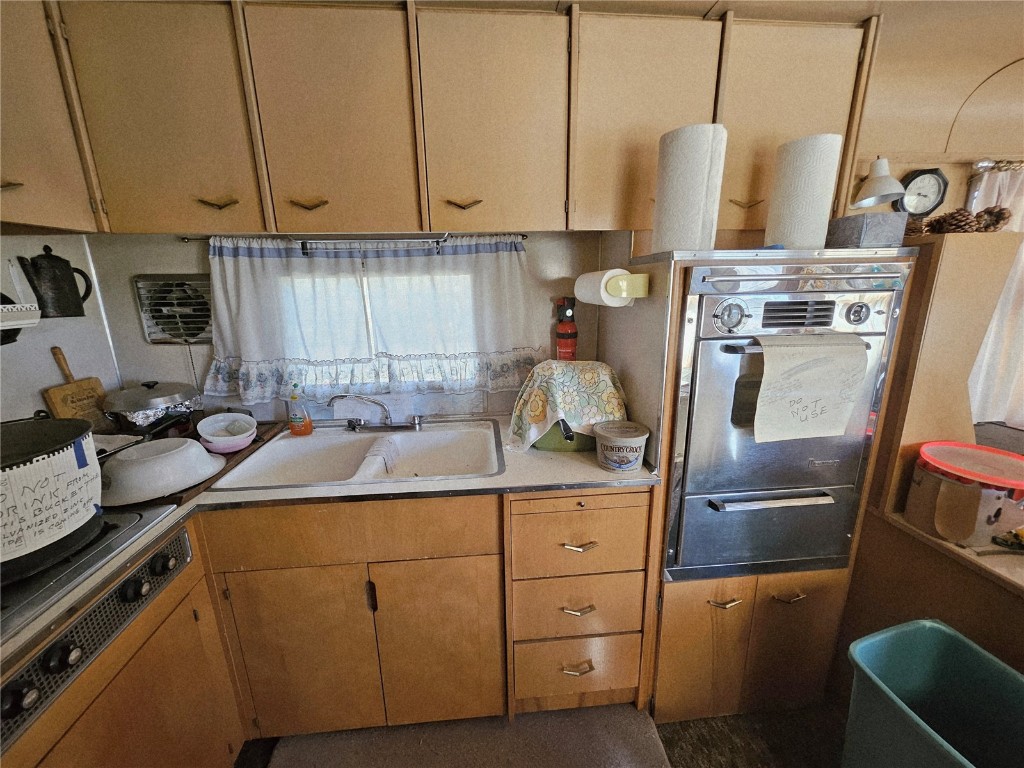 1404 Buffalo Ridge Road Como, CO 80432 - Photo 30 of 50 a kitchen with a sink a refrigerator and cabinets