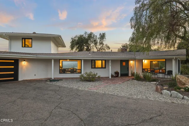 a view of house with patio outdoor seating and plants
