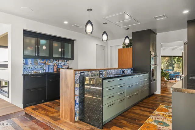 a dining room with wooden floor and a floor to ceiling window