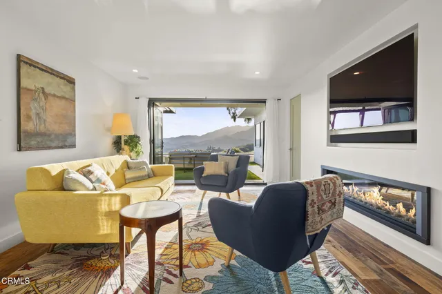 a bedroom with furniture and a large window