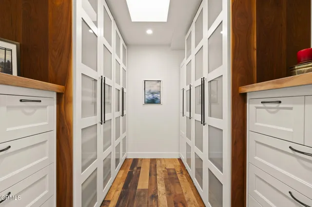 a roof deck with table and chairs and potted plants